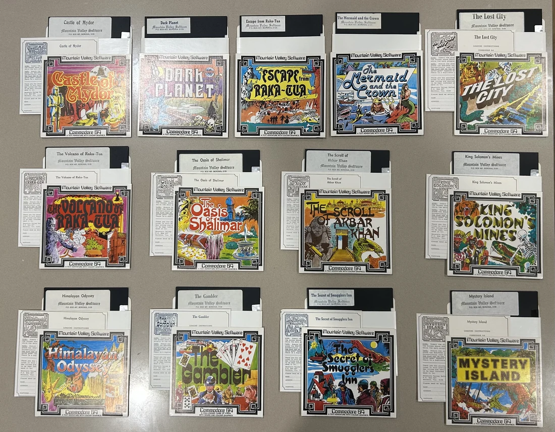 The thirteen Mountain Valley Software Commodore 64 disk releases laid out in three rows, each with its cover sleeve, labelled disk and instruction card